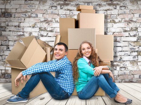 Professional movers handling office furniture and equipment