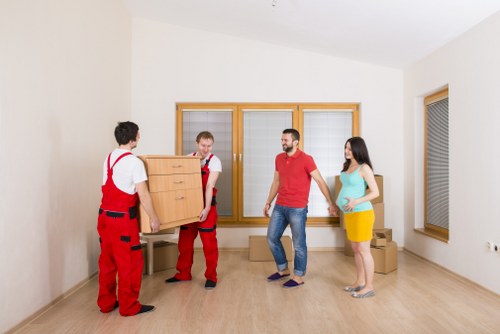 Mover wearing PPE while securing furniture inside the van during a safe relocation