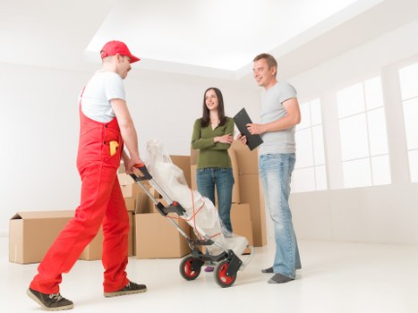 Careful lifting of a large bed frame during furniture pick-up